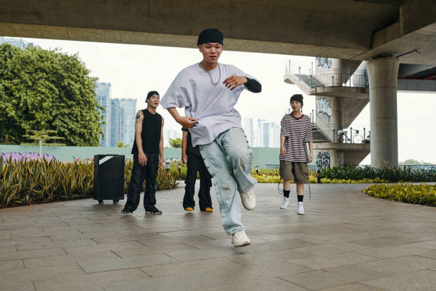 istock Dancing Hip Hop Outdoors in Urban Setting with Friends 2170948107