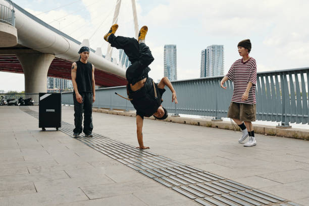 istock Breakdancer Performing Handstand Near Urban Bridge 2170948205