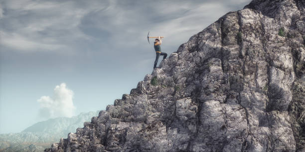 istock A man digging a ladder into a mountain with a pickaxe. 2170948268