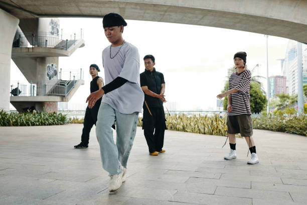 istock Young Asian Dancers Rehearsing Under Urban Bridge 2170948440