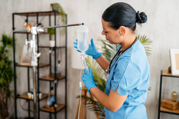 istock Home Care Nurse Preparing An IV Drip Indoors 2170948600
