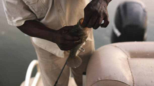 The villagers of Anomabo chat, play or work on their boats on the beach. Anomabo, Ghana