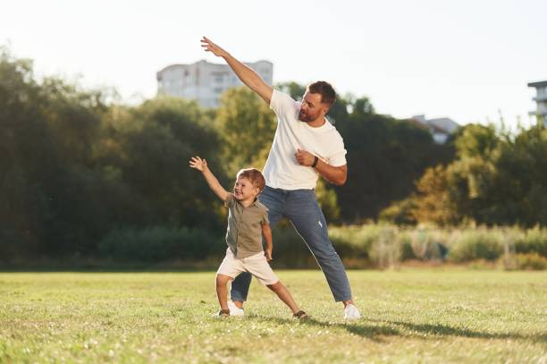 istock Flying hands gesture. Father and son are together on the field 2170951181