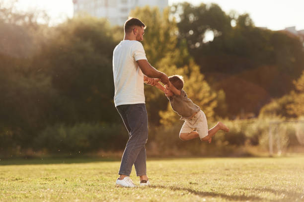 istock Holding hands, rotating. Father and son are together on the field 2170952268