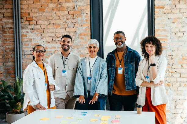 Multicultural young and senior professionals collaborating in a sophisticated business environment, showcasing diversity and teamwork