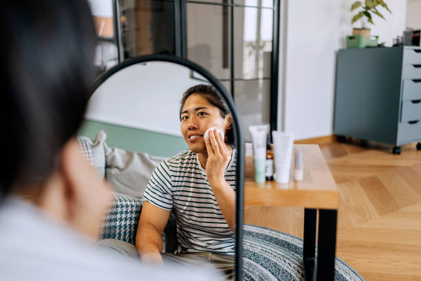 istock Young handsome man cleaning his face with a cotton pad at home 2170954037