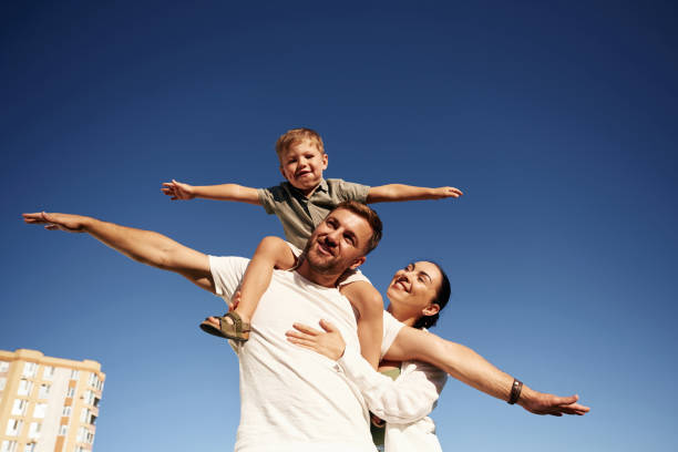 istock Mother and father are with son outdoors on the field 2170954089