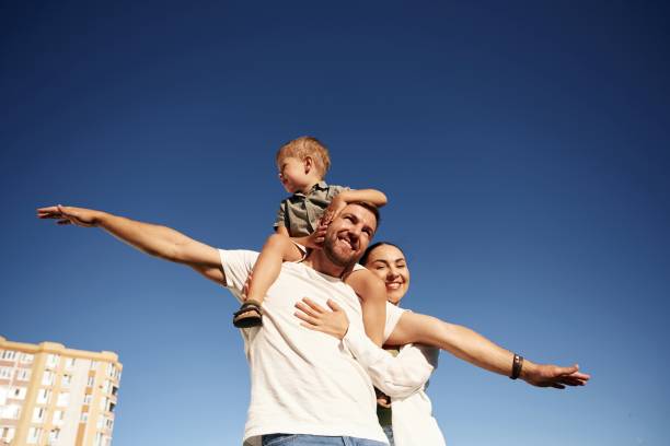 istock Mother and father are with son outdoors on the field 2170954119