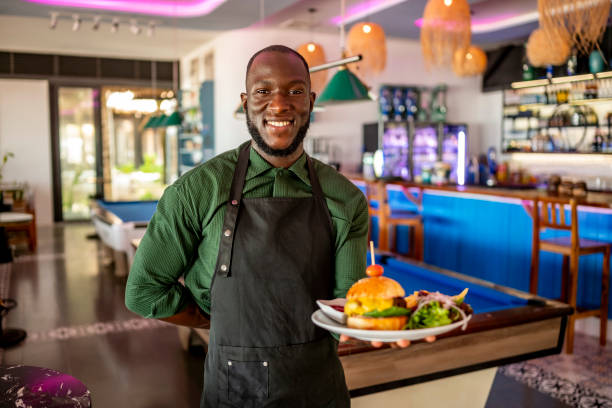 istock Cheerful Chef Presenting Delicious Burger in Modern Restaurant 2170954263