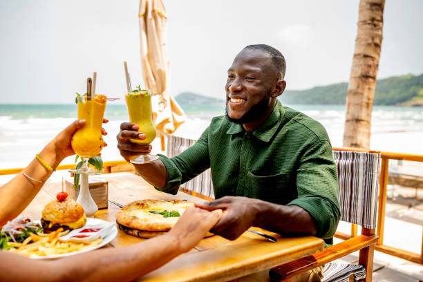 istock Friends Enjoying Lunch with Tropical Drinks at Beachside 2170954295