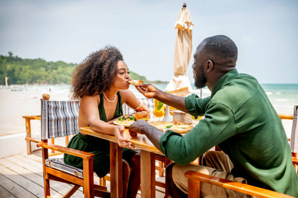 istock Romantic Couple Enjoying Lunch by the Beachside 2170954323