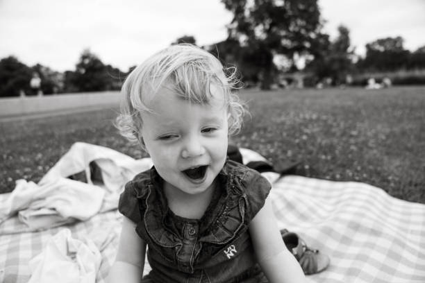 istock Two year old blonde daughter happily explaining something at a Hyde Park picnic near Pricess Diana Memorial Fountain. 2170954689