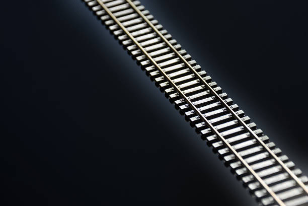 istock Toy railway on glossy black background. Railway line. Selective focus effect. 2170956035