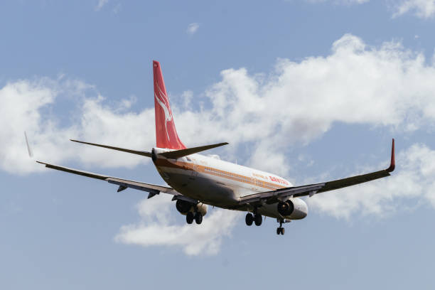 MELBOURNE, AUSTRALIA - SEPTEMBER 07, 2024: A Qantas Boeing 737-800 in retro livery flies into Melbourne from Perth on September 7th 2024