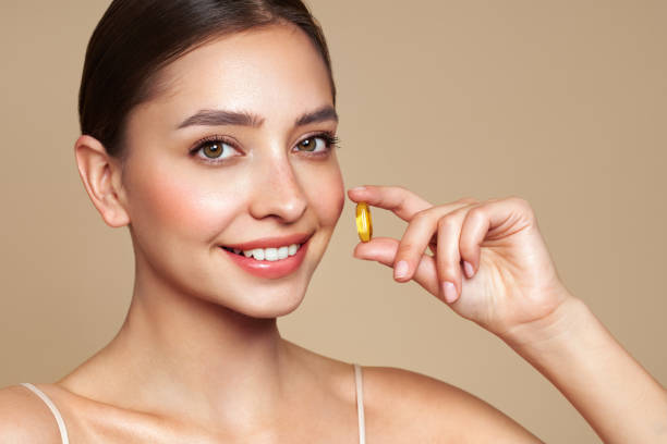 istock Beautiful Girl With Pill With Cod Liver Oil Omega-3 2170957880