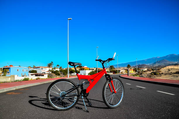 istock A red bicycle is parked on the side of a road 2170958861