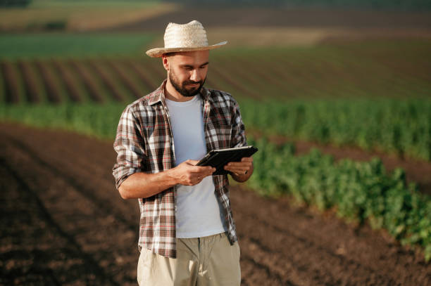 istock Digital tablet in hands. Farmer is on the agricultural field 2170959245