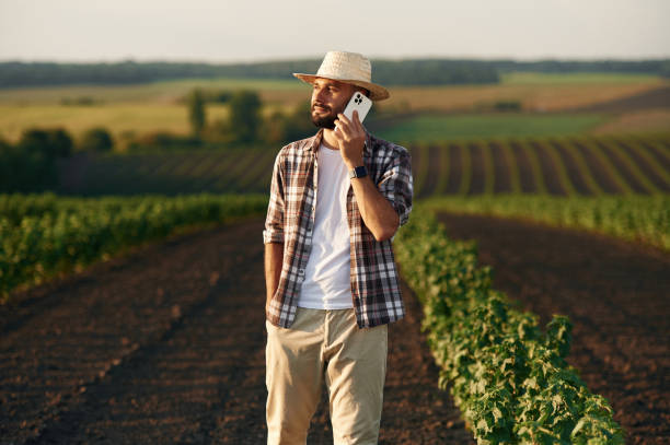 istock Talking by a phone. Farmer is on the agricultural field 2170959583