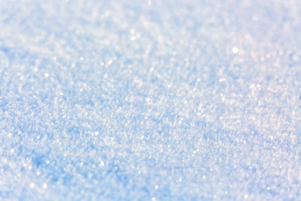 Snow surface texture background. Crystals and snowflakes. Winter natural christmas background. Selective focus.