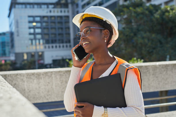 istock Confident Female Construction Worker on Phone in City Setting 2170965141