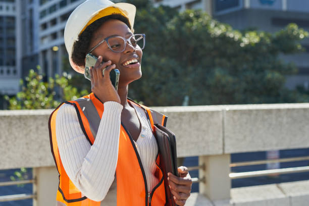 istock Confident Female Engineer Holding Phone and Tablet Outdoors 2170965287