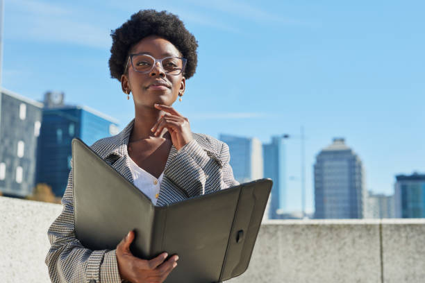 Confident Businesswoman with Folder in Urban Setting