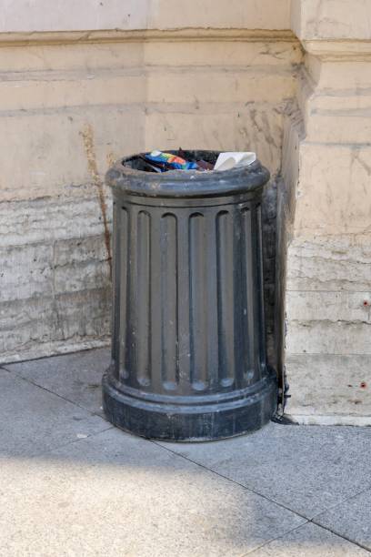 istock public trash can on city street filled with garbage. plastic waste in trash can container. 2170966273