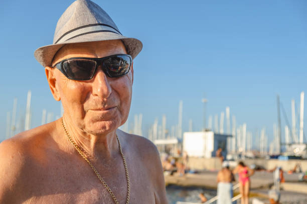 Senior man posing with his fedora hat and sunglasses