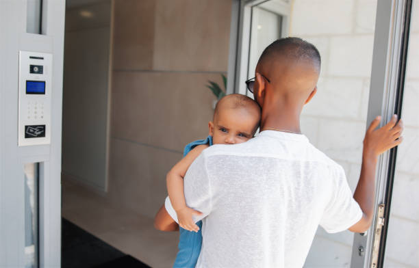 istock Father carrying baby while entering building 2170968999