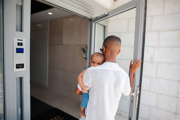 istock Father carrying baby while entering building 2170969001