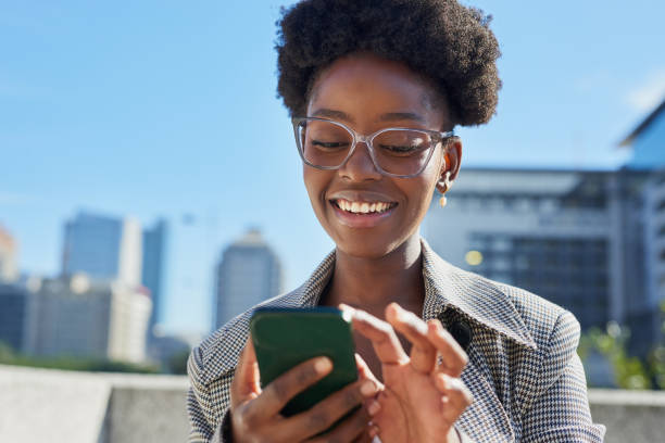 istock Smiling Woman Using Smartphone in Urban City Environment 2170969647