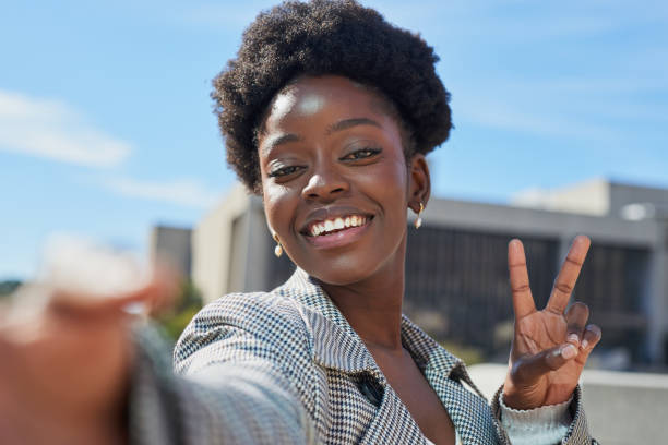 istock Confident Woman Enjoying a Sunny Day with Peace Sign 2170969898