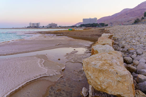 Ein Bokek, Israel - January 19, 2024: Sunset view of the Dead Sea coast and hotels, in the Ein Bokek resort, Judaean Desert, southern Israel