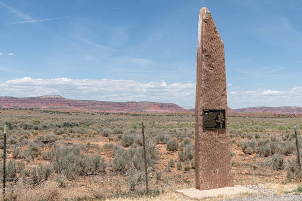 Woman Hikes Behind Cairn in Desert Trail in Utah