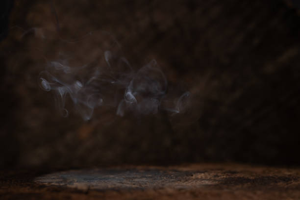 istock Swirling smoke on a dark textured background 2170972798
