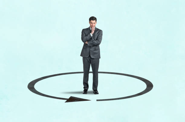 istock Man Looking Down At Arrow That Circles Around Him 2170978685