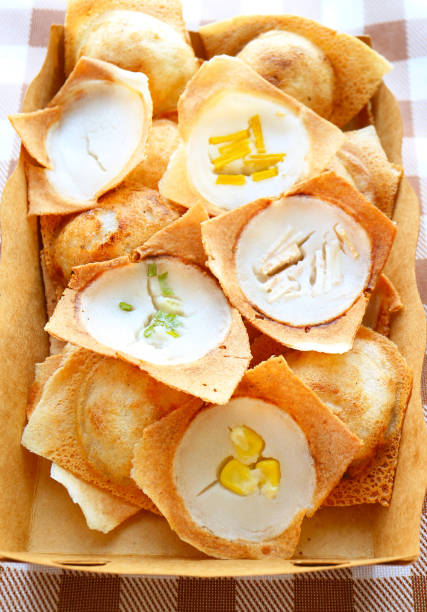 Sweet and fragrant Thai coconut milk pancakes called Kanom Krok with Assorted Topping of Fruits and vegetables