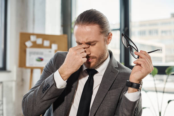 istock Handsome businessman feeling stressed in modern office environment during working hours 2170979377