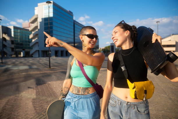 istock Two young woman walking with skateboard 2170984989