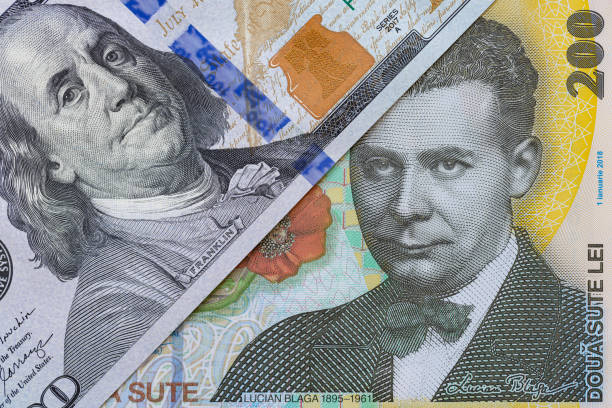 istock 100 dollar banknote and 200 Romanian Lei banknotes 2170985926