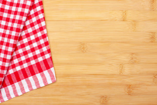 istock Red checkered dish towel  on a wooden surface. 2170985953