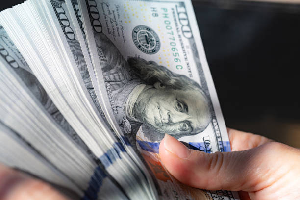 istock fan of US 100 dollar banknotes in hand 2170986104