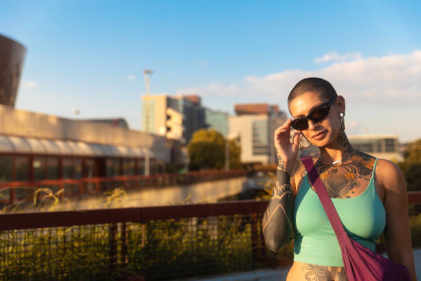 Happy tattooed young woman looking at camera