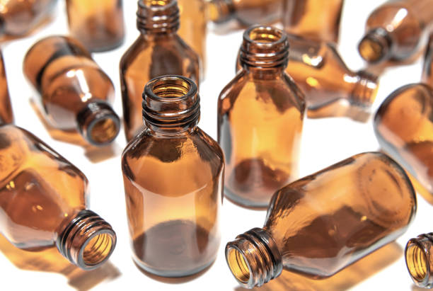 Glass  pharmaceutical bottles made of brown glass on light background. Containers and package for medicines. Pharmacy and pharmaceutical industry