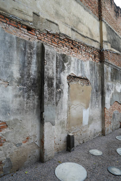 istock Close up Cracked red brick in old concrete cement wall 2170990094