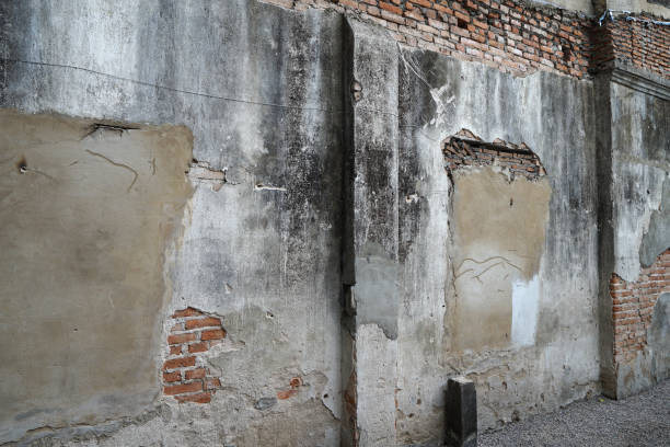 istock Close up Cracked red brick in old concrete cement wall 2170990140