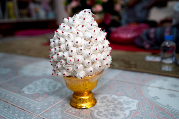 In a traditional Northern Thai wedding, one of the most significant items is the Sai Sin, a sacred white thread made from cotton. This thread is used in the ritual of tying the wrists of the bride and groom, symbolizing the bond and unity in their marriage.