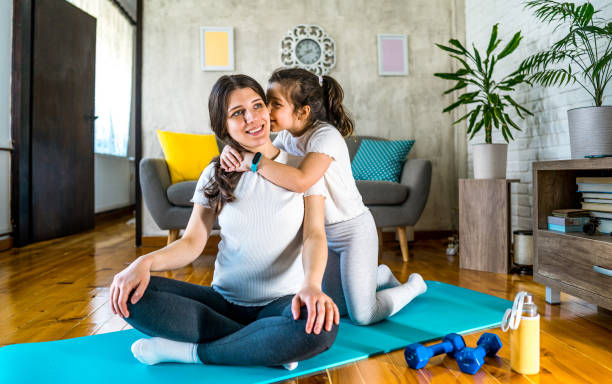 istock Daughter kissing her mother during exercise at home 2170997105