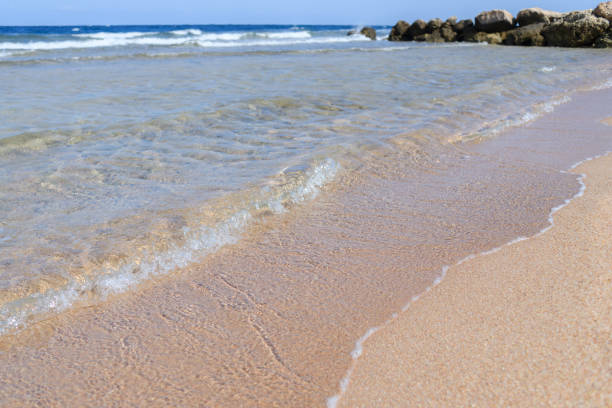 Waves on sea shore with stones on beach