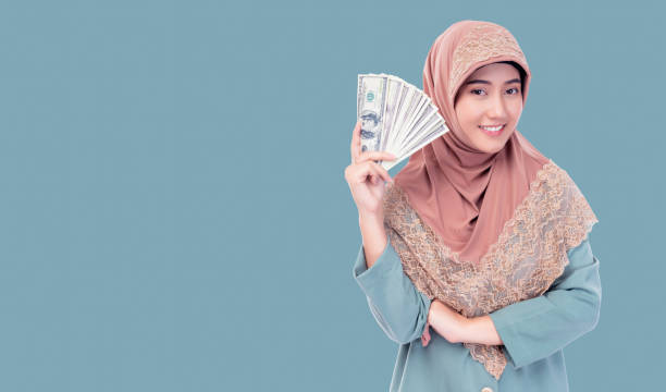 istock Muslim Woman Holding Cash 2170997496